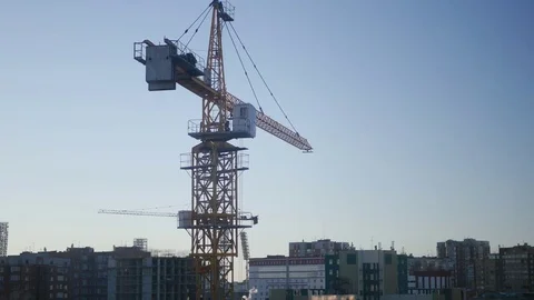 Construction crane in the blue sky and sunset in the sun, on the construction Stock Footage 74581104