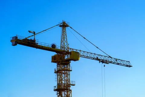 Construction crane on the blue sky background Stock Photos