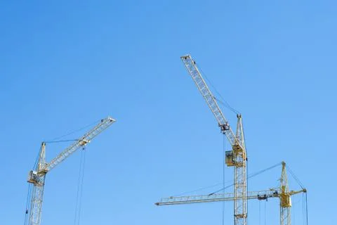 Construction crane on blue sky background Stock Photos