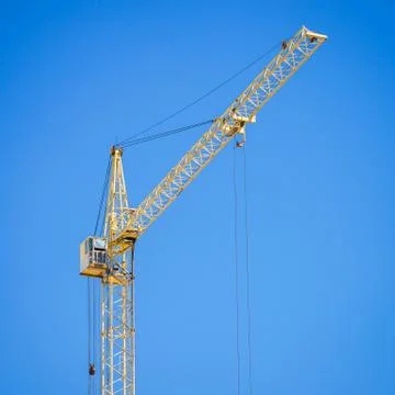 Construction crane on blue sky background Stock Photos