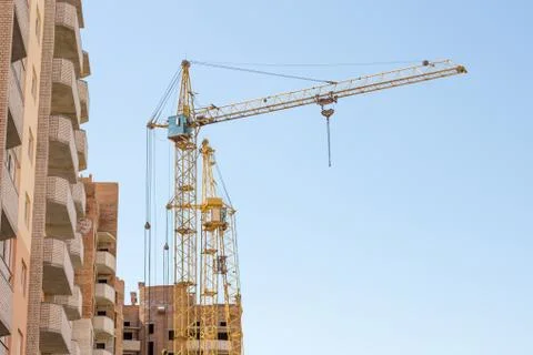 Construction crane on blue sky background Stock Photos