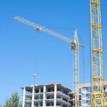 Construction crane on blue sky background Stock Photos