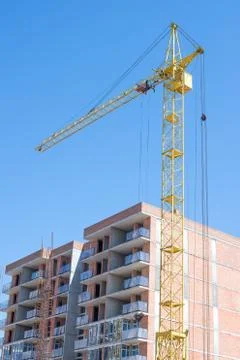 Construction crane on blue sky background Stock Photos