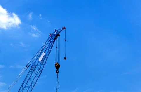 Construction crane on blue sky background in progress at Construction Site. Stock-Fotos