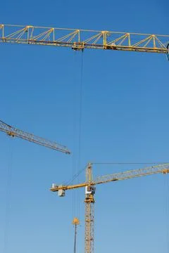 Construction crane on a blue sky background. construction of residential Stock Photos