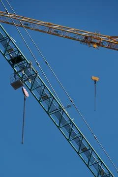 Construction crane on blue sky background, close-up. Industrial background Stock Photos