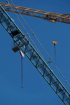 Construction crane on blue sky background, close-up. Industrial background Foto stock