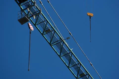 Construction crane on blue sky background, close-up. Industrial background Stock Photos