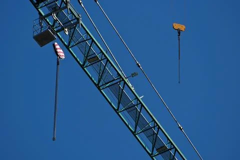 Construction crane on blue sky background, close-up. Industrial background Stock Photos