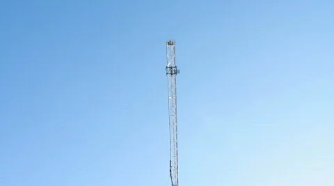 Construction crane in blue sky CU pan Stock Footage 706360