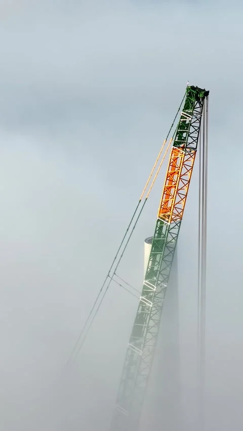 Construction Crane Boom Rising Above Dense Fog at Industrial Work Site Stock Footage 336238240