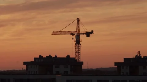 Construction crane in a bright light of sunset Stock Footage 136207377