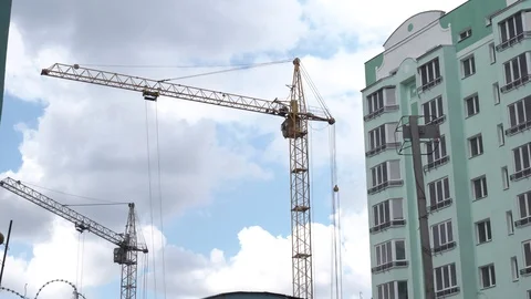 Construction crane on a building background. Territory of construction houses Stock Footage 129792020