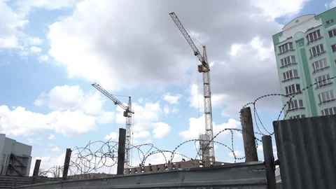 Construction crane on a building background. Territory of construction houses Stock Footage 129793120