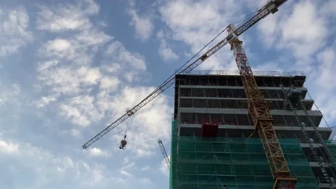 Construction crane on building site building skyscraper with blue sky. Stock Footage 218613094