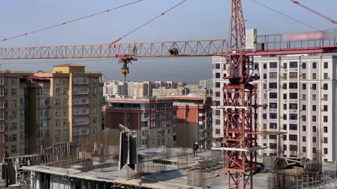 A construction crane carries heavy construction parts Stock Footage 316879798