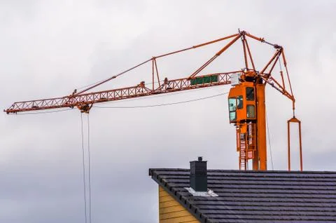 Construction crane with a cloudy sky in the background, building industry equ Foto stock