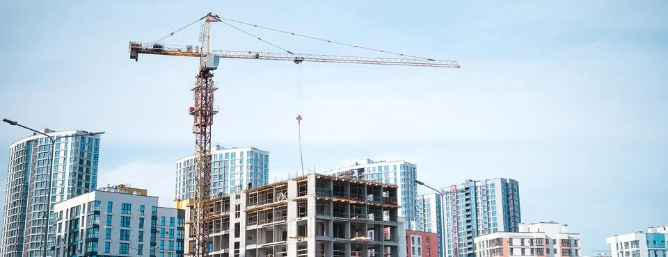 Construction crane in the construction of multi-storey buildings Stock Photos