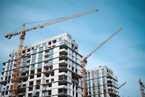 Construction crane in the construction of multi-storey buildings Stock Photos