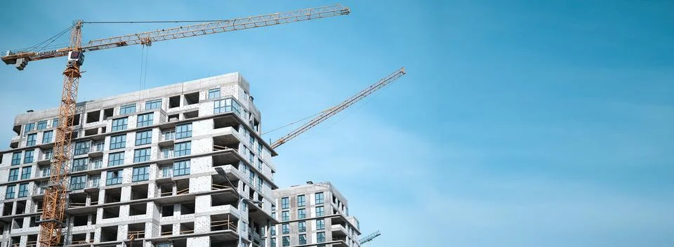 Construction crane in the construction of multi-storey buildings Stock Photos