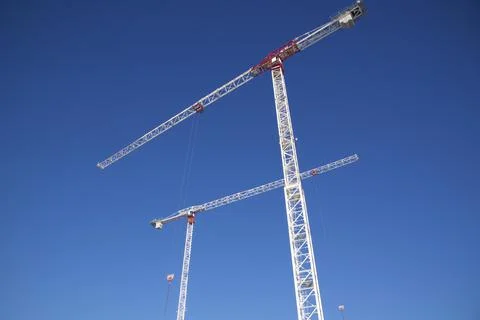 Construction crane in a construction site with blue sky background Stock Photos