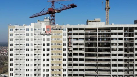 Construction crane on the construction site vertical flying over down to top Stock Footage 128282610