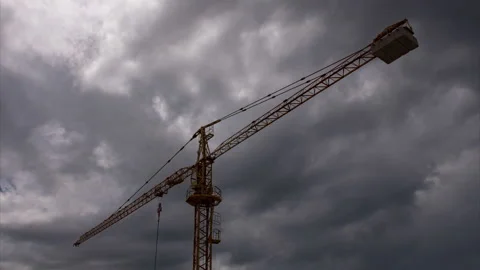 Construction crane with dark clouds moving in the background until clear sky Stock Footage 132665815