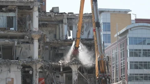 Construction crane demolishing a building to make room for a park Video stock 250360170