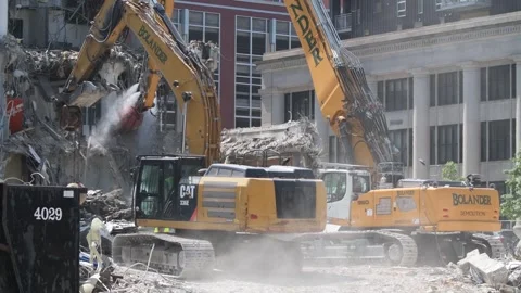 Construction crane demolishing a building to make room for a park Video stock 250360364