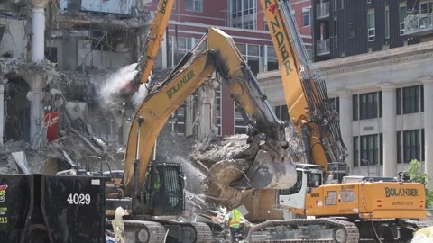 Construction crane demolishing a building to make room for a park Video stock 250360537