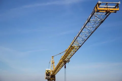 A construction crane during work at a construction site Stock Photos