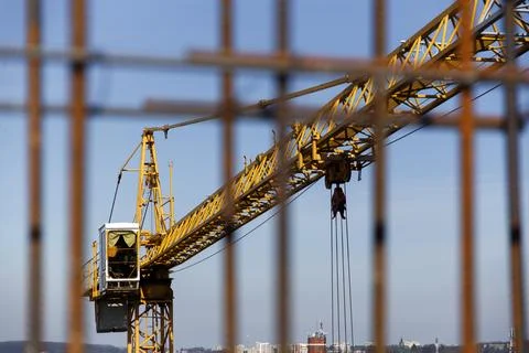 A construction crane during work at a construction site Stock Photos