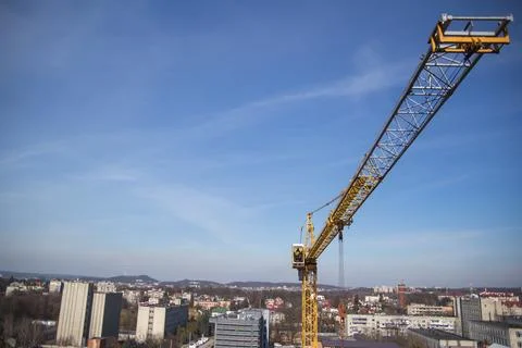 A construction crane during work at a construction site Stock Photos