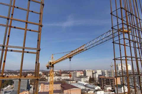 A construction crane during work at a construction site Stock Photos