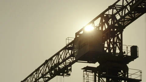 Construction Crane Eclipsing Sun While Turning Видео 224317405