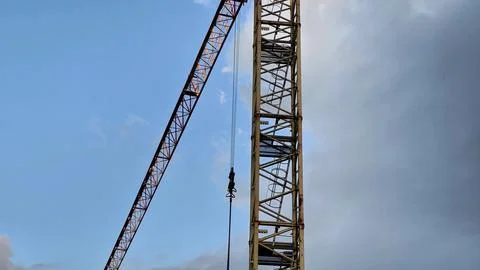 A Construction Crane Efficiently Operating Against a Beautifully Clear Blue Sky Stock Photos