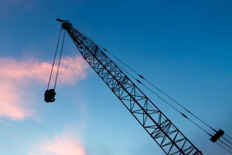 Construction crane on evening background Stock Photos
