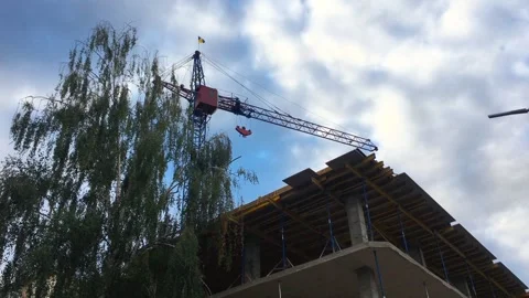 Construction crane with the flag of Ukraine, construction of a house Stock Footage 251948112