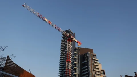 Construction crane in front of a skyscraper Stock-Footage 102001170