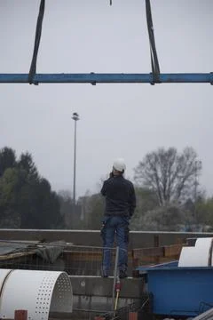 Construction crane with heavy load Stock Photos