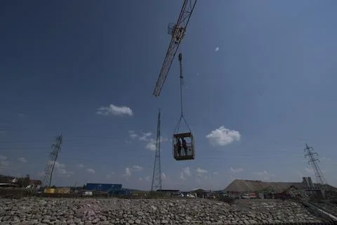 Construction crane with heavy load Stock Photos