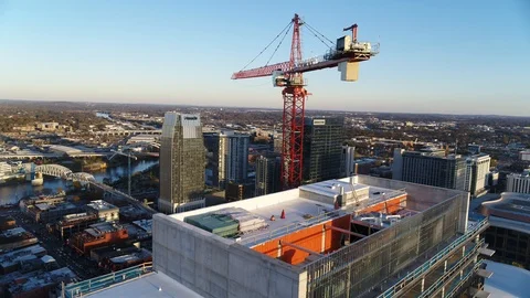Construction crane high above Nashville downtown showing rapid growth of city Stock Footage