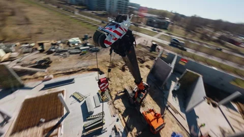 Construction crane hoisting building materials, displaying dynamic perspectives Video stock 306397695