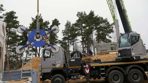 Construction crane holds suction cup for installing windows. Stock Footage 293218093