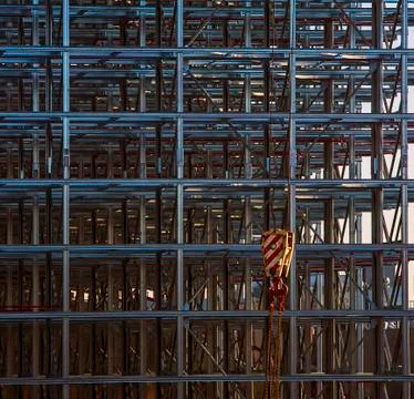 Construction crane hook infront of a metal structure Stock Photos