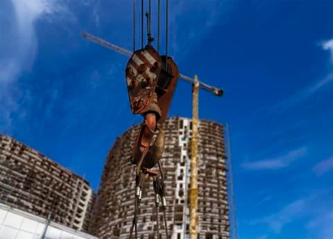 Construction crane hook with multi-storey building under construction Stock Photos