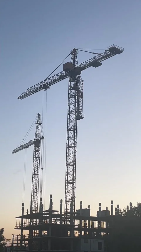 Construction Crane Lifting Concrete Slabs at Residential Building Site Stock Footage 346721775