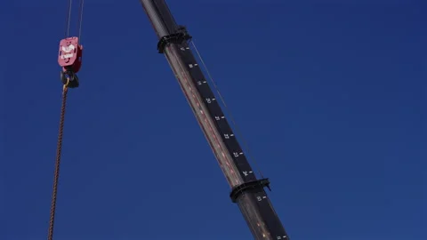 Construction Crane Lifting Equipment Against Clear Blue Sky Stock Footage 343357810