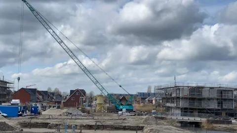 Construction crane lifts large window frame through the air Stock-Footage 151989605