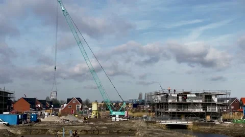 Construction crane lifts large window frame through the air Stock-Footage 151990392